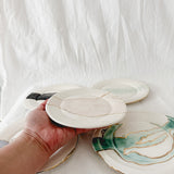 Handmade ceramic salad and dessert dishes with a watercolor glaze and real 22k gold luster line, seconds-sale pieces from Muddy Heart