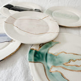 Handmade ceramic salad and dessert dishes with a watercolor glaze and real 22k gold luster line, seconds-sale pieces from Muddy Heart