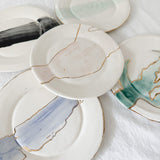 Handmade ceramic salad and dessert dishes with a watercolor glaze and real 22k gold luster line, seconds-sale pieces from Muddy Heart