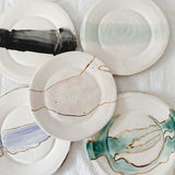 Handmade ceramic salad and dessert dishes with a watercolor glaze and real 22k gold luster line, seconds-sale pieces from Muddy Heart