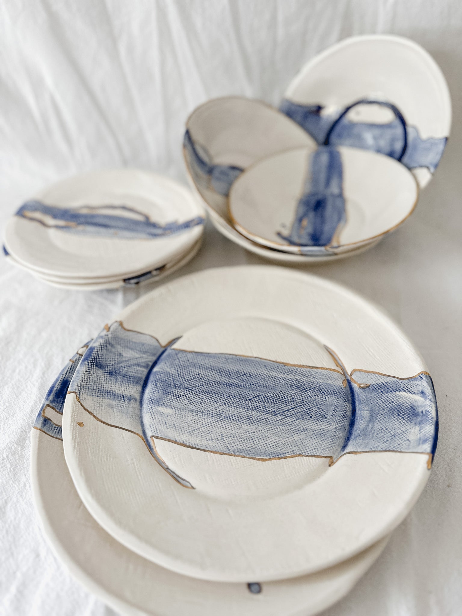Handmade cobalt watercolor ceramic dinnerware with gold luster detailing