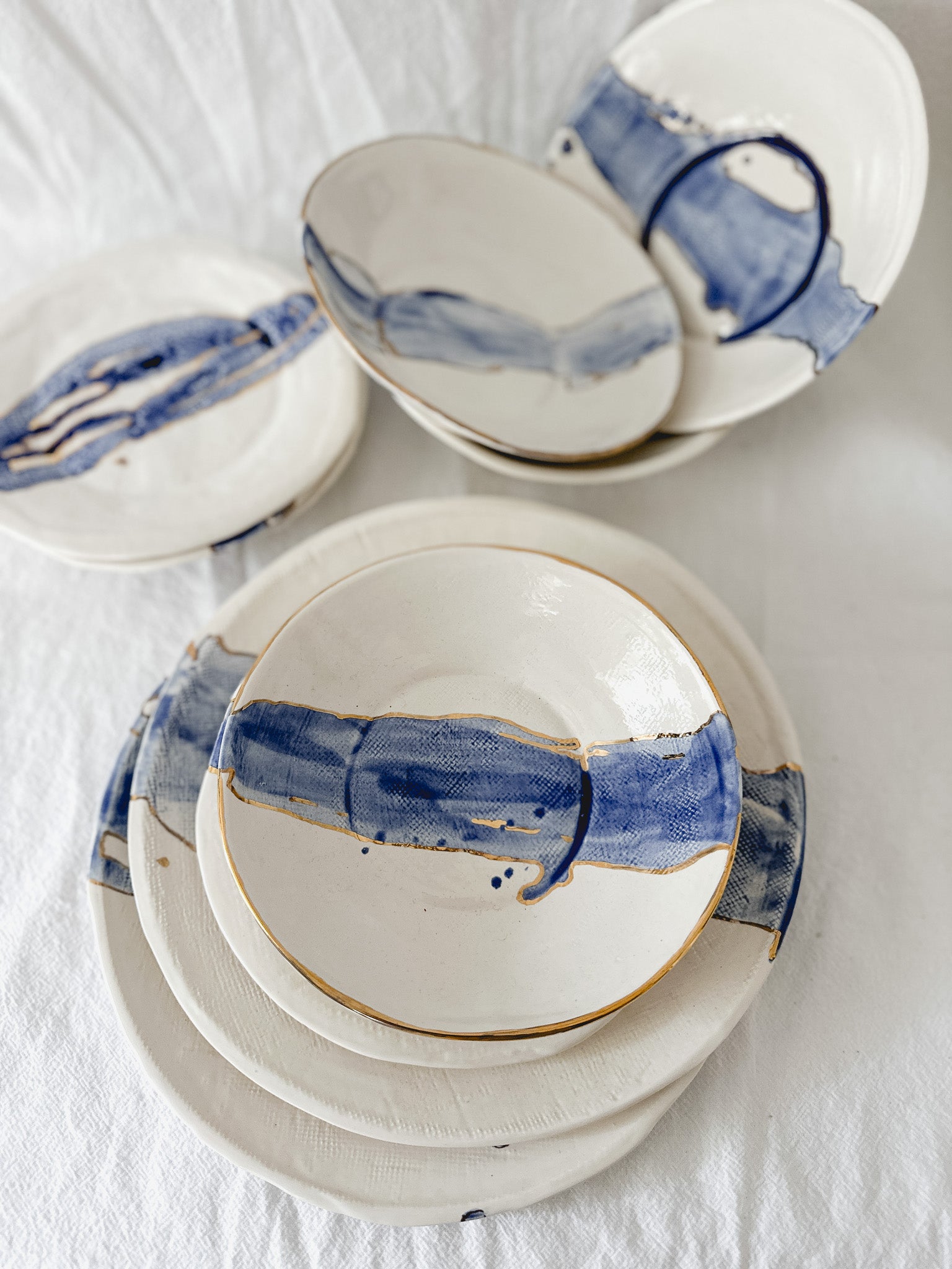 One-of-a-kind cobalt watercolor ceramic dinnerware with 22k gold luster trim
