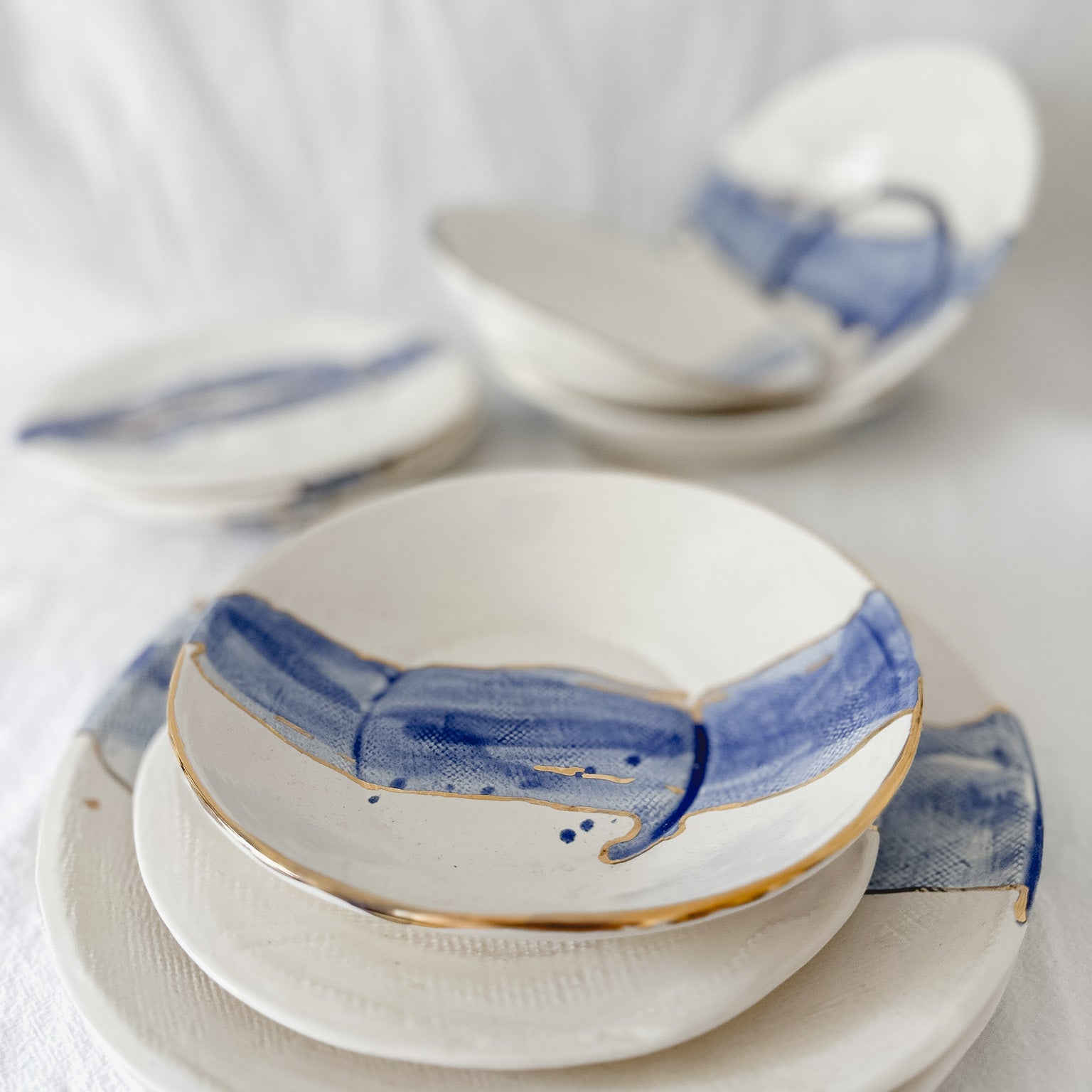 Cobalt watercolor ceramic dinnerware with 22k gold luster trim, handmade