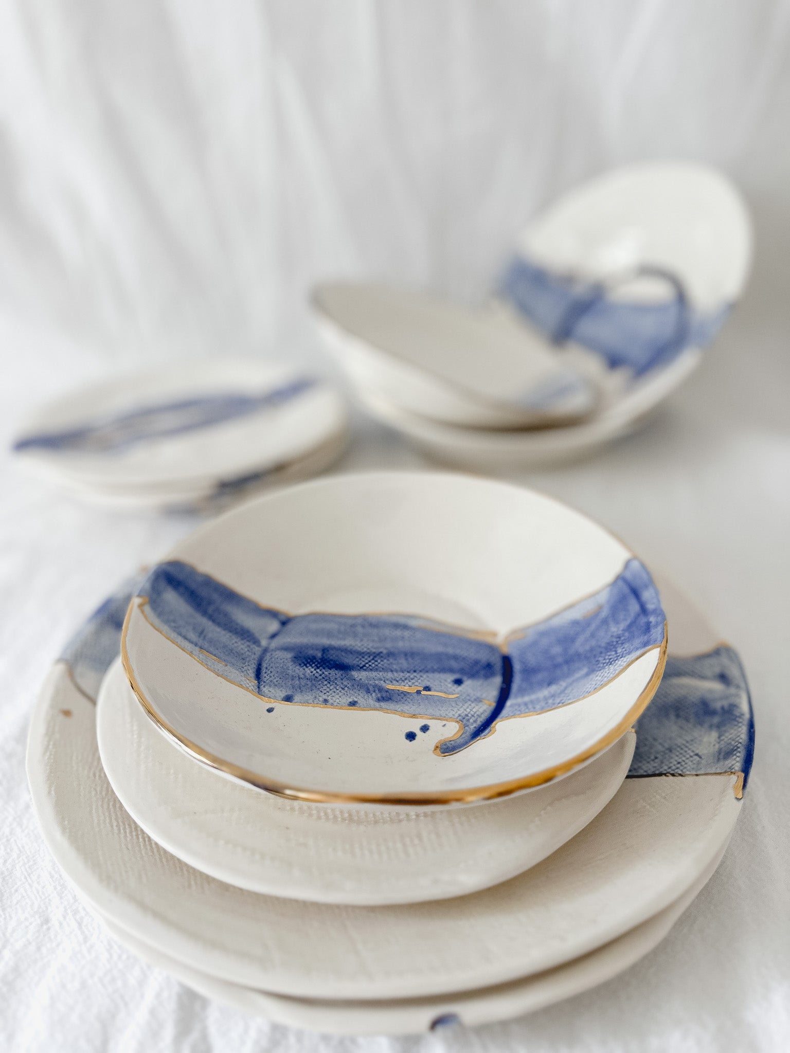 Cobalt watercolor ceramic dinnerware with 22k gold luster trim, handmade