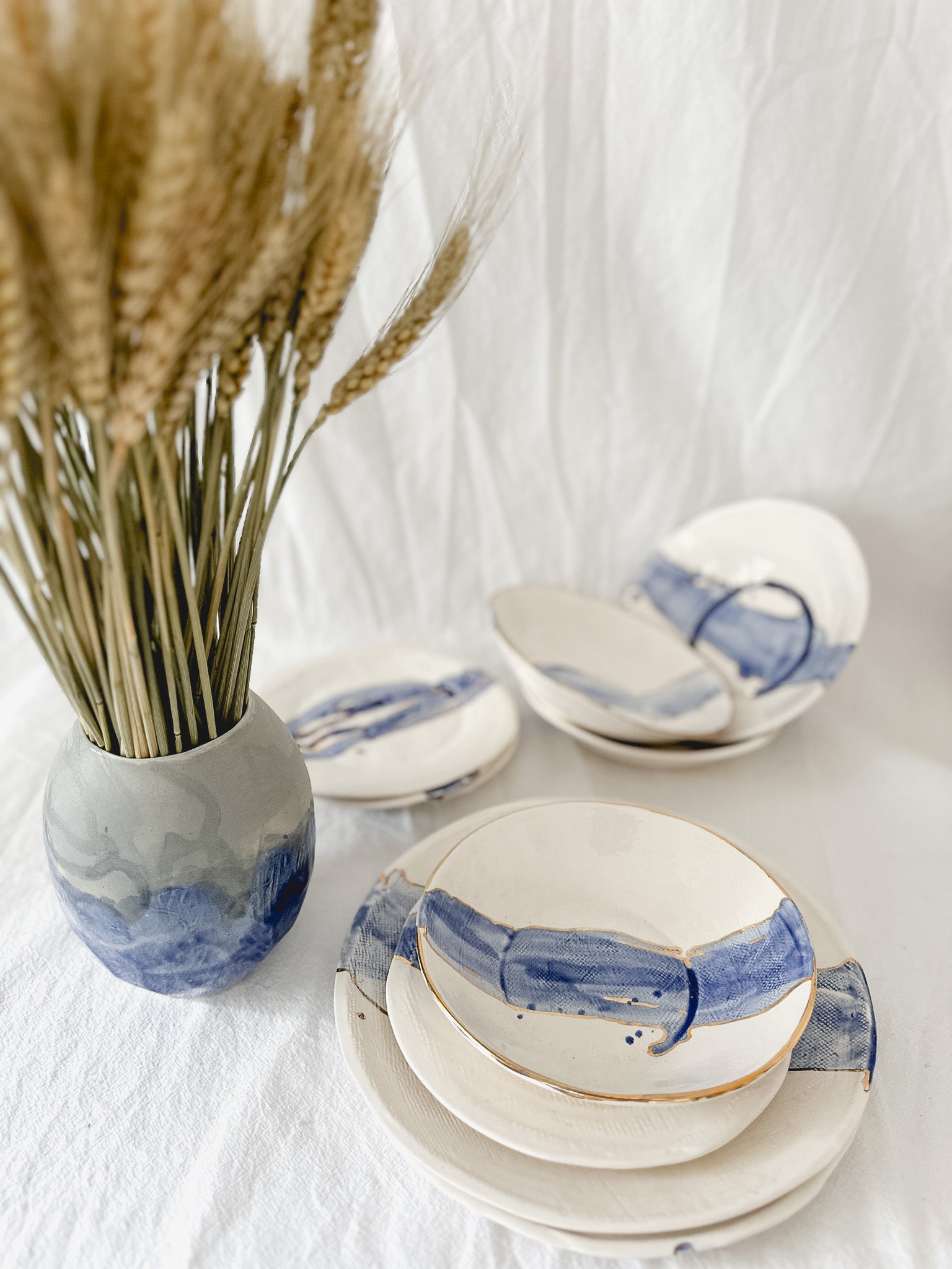 Watercolor cobalt ceramic dinnerware piece with a gold luster edge, handmade