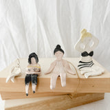 Small handmade ceramic doll figurines in assorted styles, one-of-a-kind seconds-sale collectibles from Muddy Heart