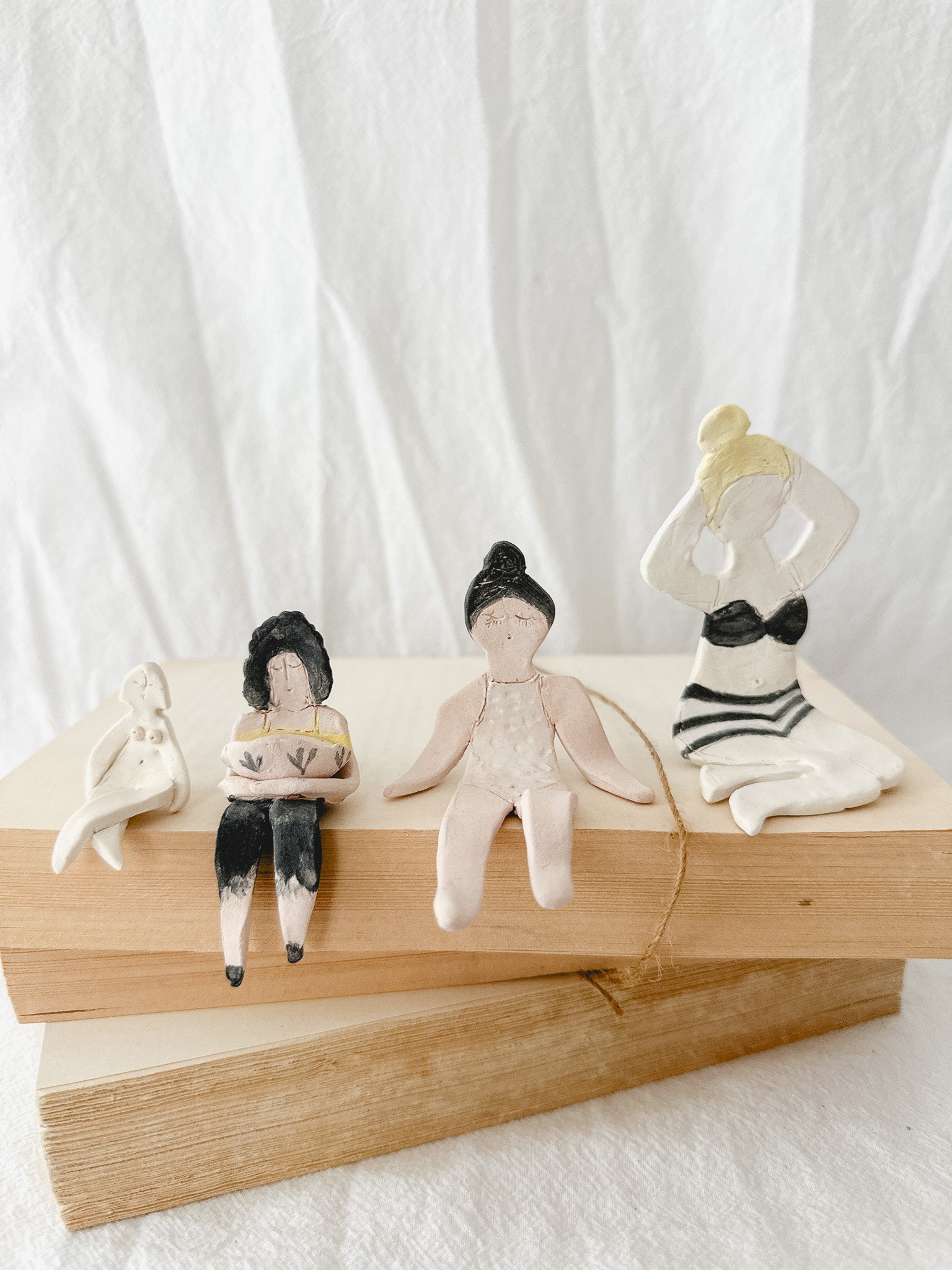 Small handmade ceramic doll figurines in assorted styles, one-of-a-kind seconds-sale collectibles from Muddy Heart