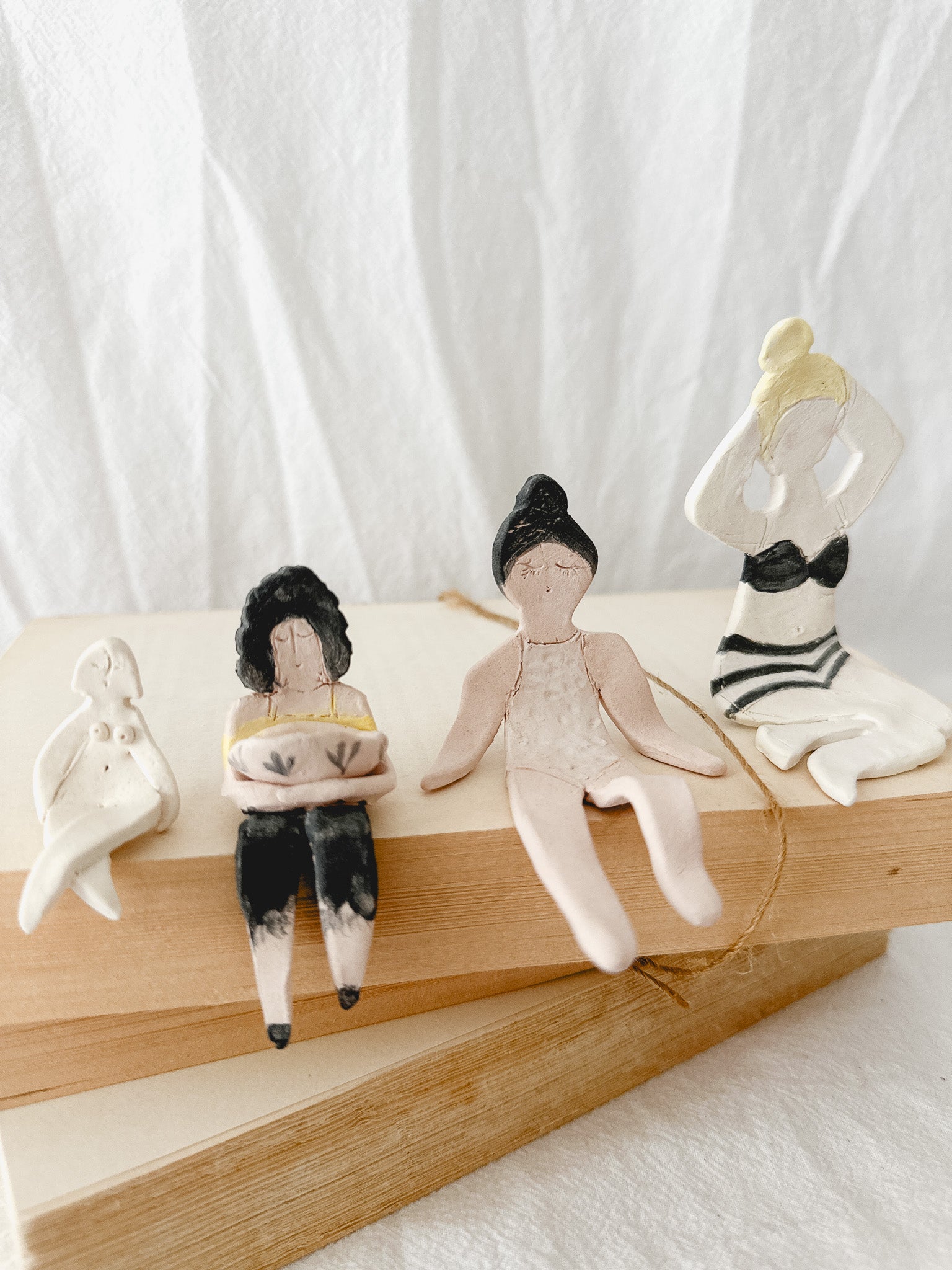 Small handmade ceramic doll figurines in assorted styles, one-of-a-kind seconds-sale collectibles from Muddy Heart