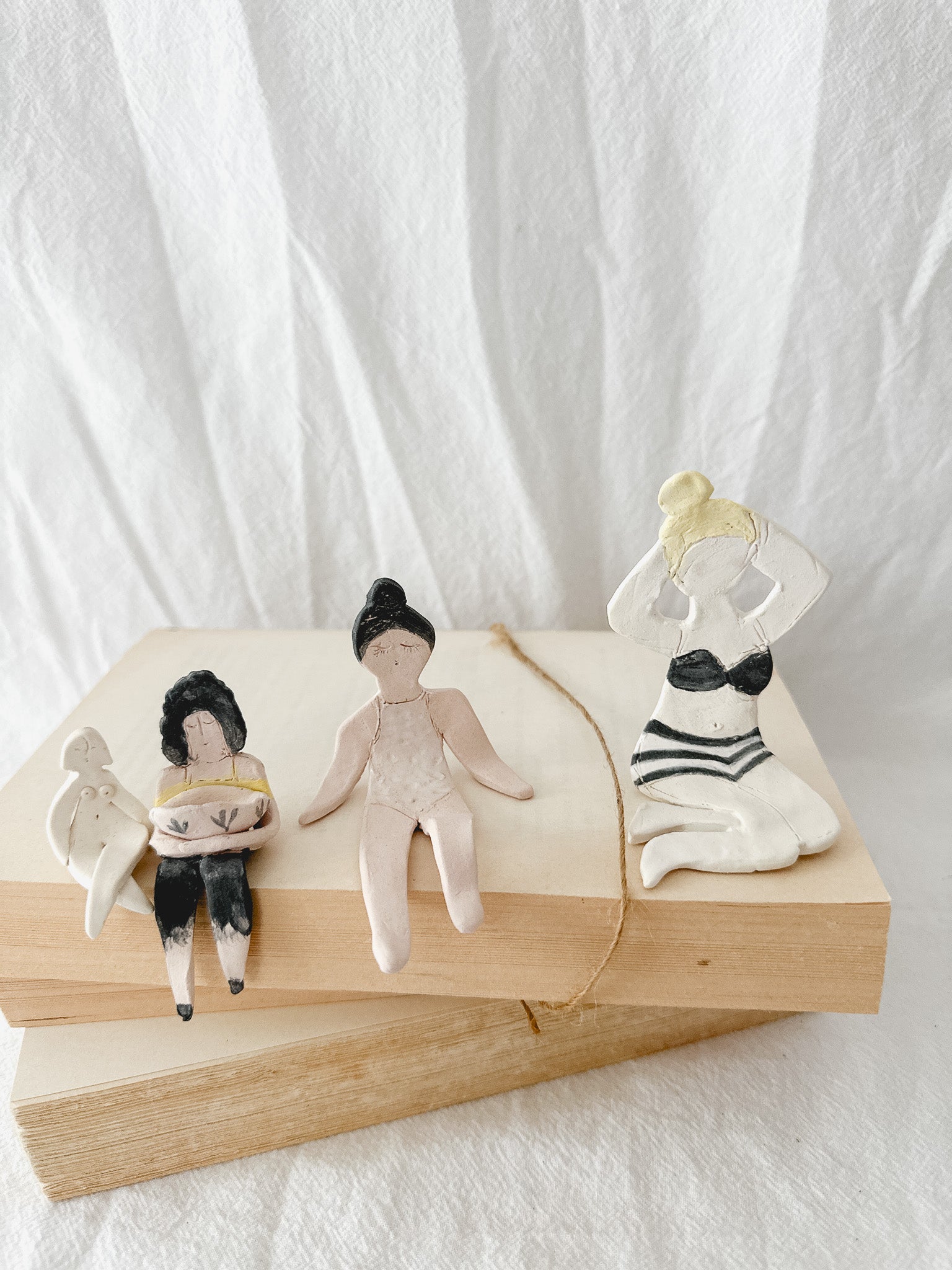 Small handmade ceramic doll figurines in assorted styles, one-of-a-kind seconds-sale collectibles from Muddy Heart