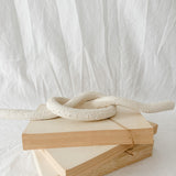 Handmade ceramic love knot decor object in textured white glaze, 12 inches long, one-of-a-kind piece from Muddy Heart