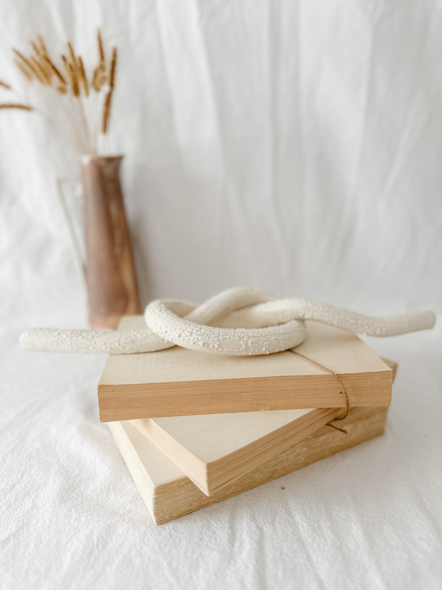 Handmade ceramic love knot decor object in textured white glaze, 12 inches long, one-of-a-kind piece from Muddy Heart