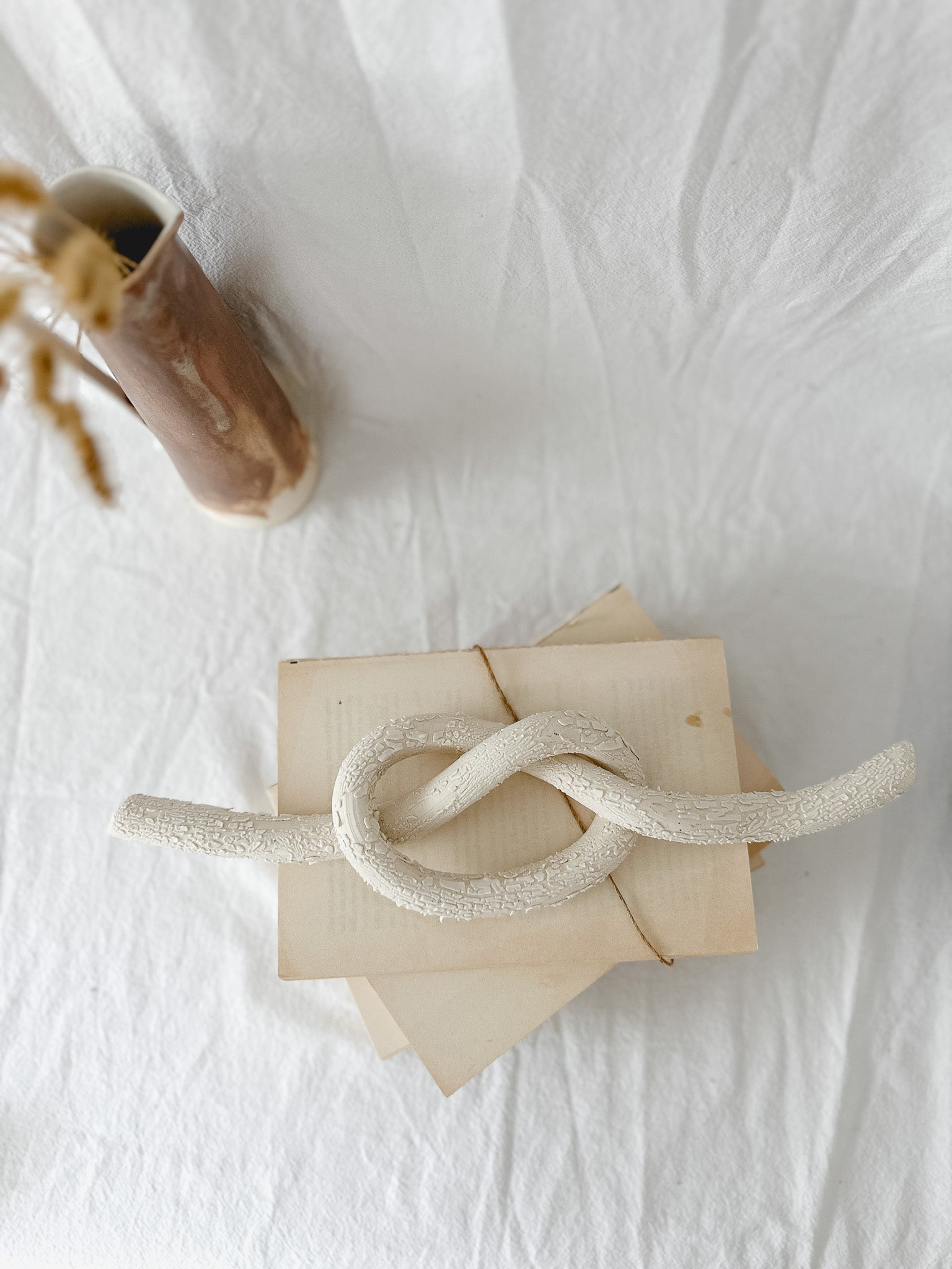 Handmade ceramic love knot decor object in textured white glaze, 12 inches long, one-of-a-kind piece from Muddy Heart