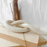Handmade ceramic love knot decor object in textured white glaze, 12 inches long, one-of-a-kind piece from Muddy Heart
