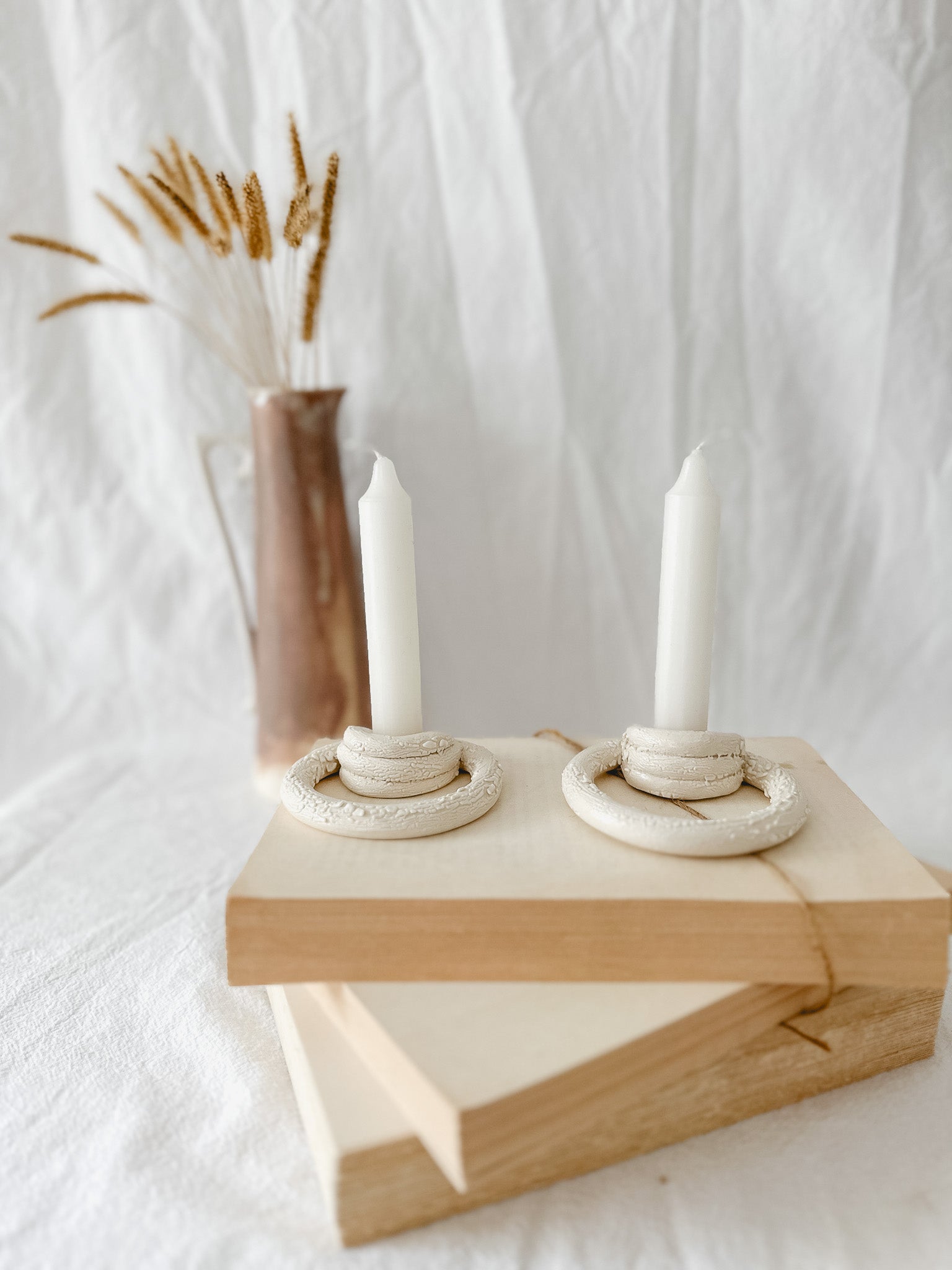 Handmade ceramic taper candle holder formed from interlocking loops, seconds-sale piece from Muddy Heart