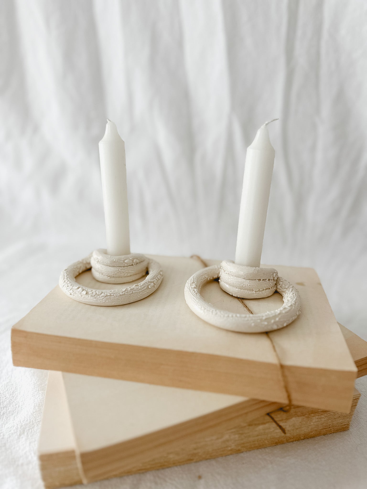 Handmade ceramic taper candle holder formed from interlocking loops, seconds-sale piece from Muddy Heart