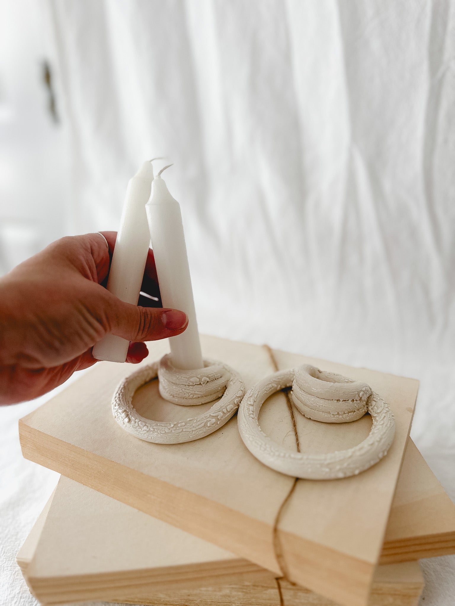 Handmade ceramic taper candle holder formed from interlocking loops, seconds-sale piece from Muddy Heart