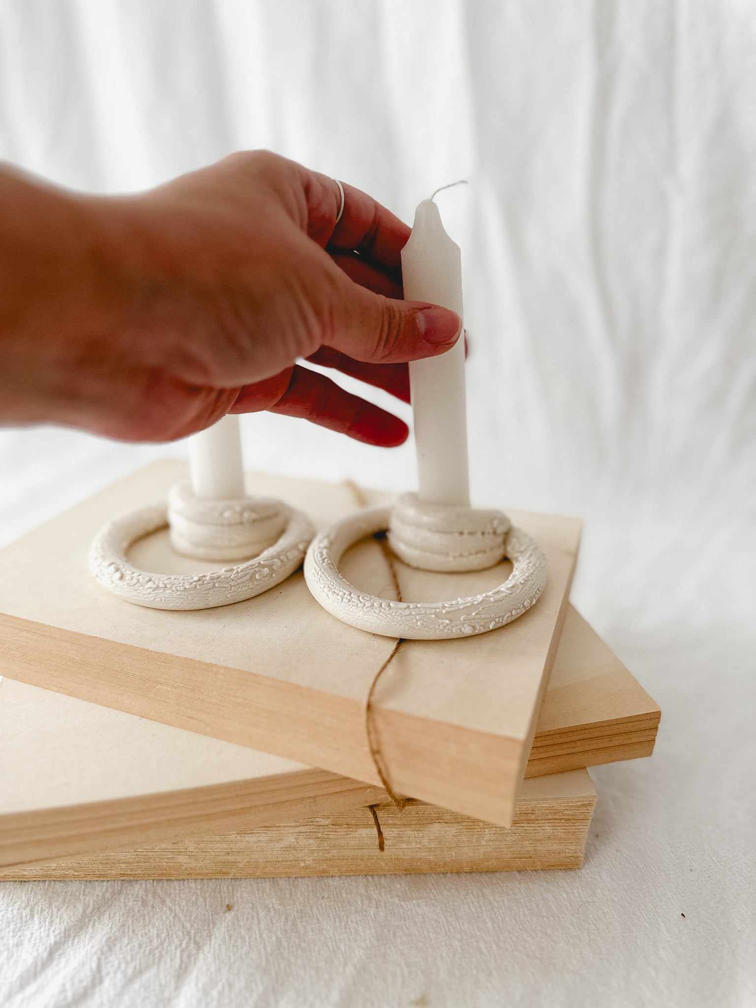 Handmade ceramic taper candle holder formed from interlocking loops, seconds-sale piece from Muddy Heart