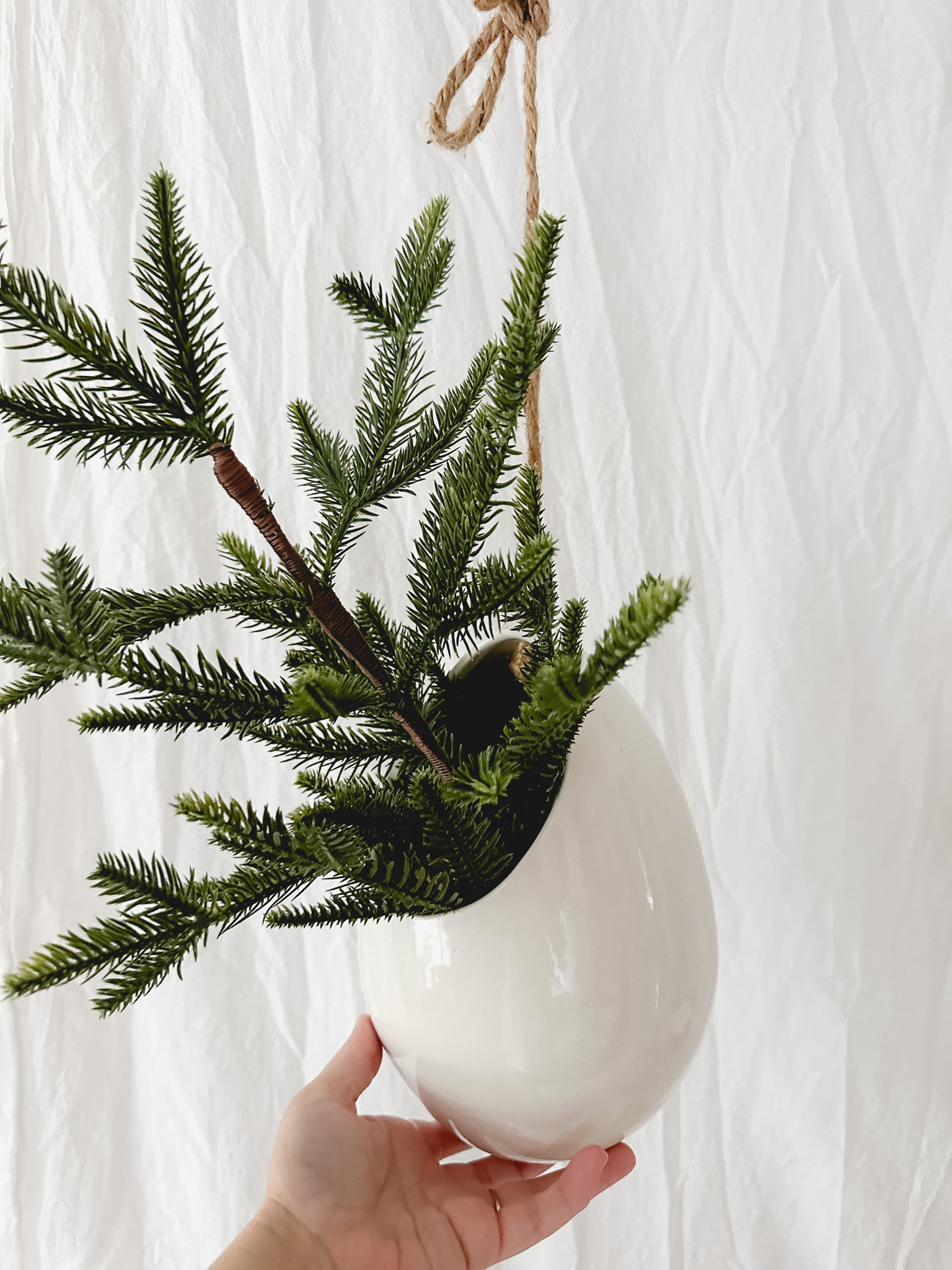 Handmade gloss white ceramic pod-shaped hanging vessel on an 18-inch rope, for flowers or trailing plants, seconds-sale piece from Muddy Heart