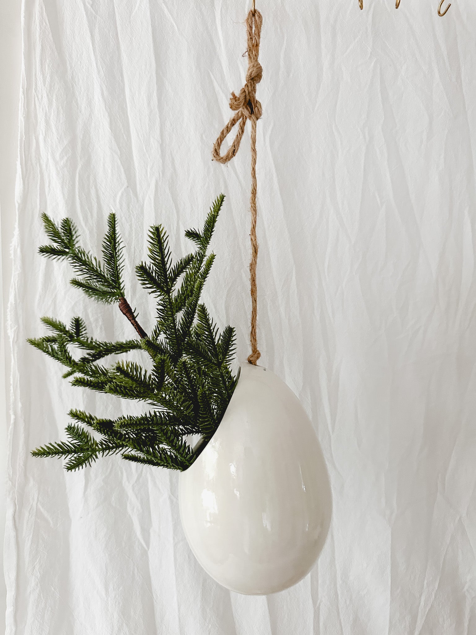 Handmade gloss white ceramic pod-shaped hanging vessel on an 18-inch rope, for flowers or trailing plants, seconds-sale piece from Muddy Heart