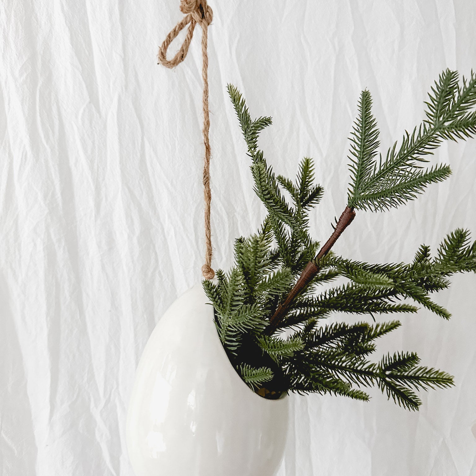 Handmade gloss white ceramic pod-shaped hanging vessel on an 18-inch rope, for flowers or trailing plants, seconds-sale piece from Muddy Heart