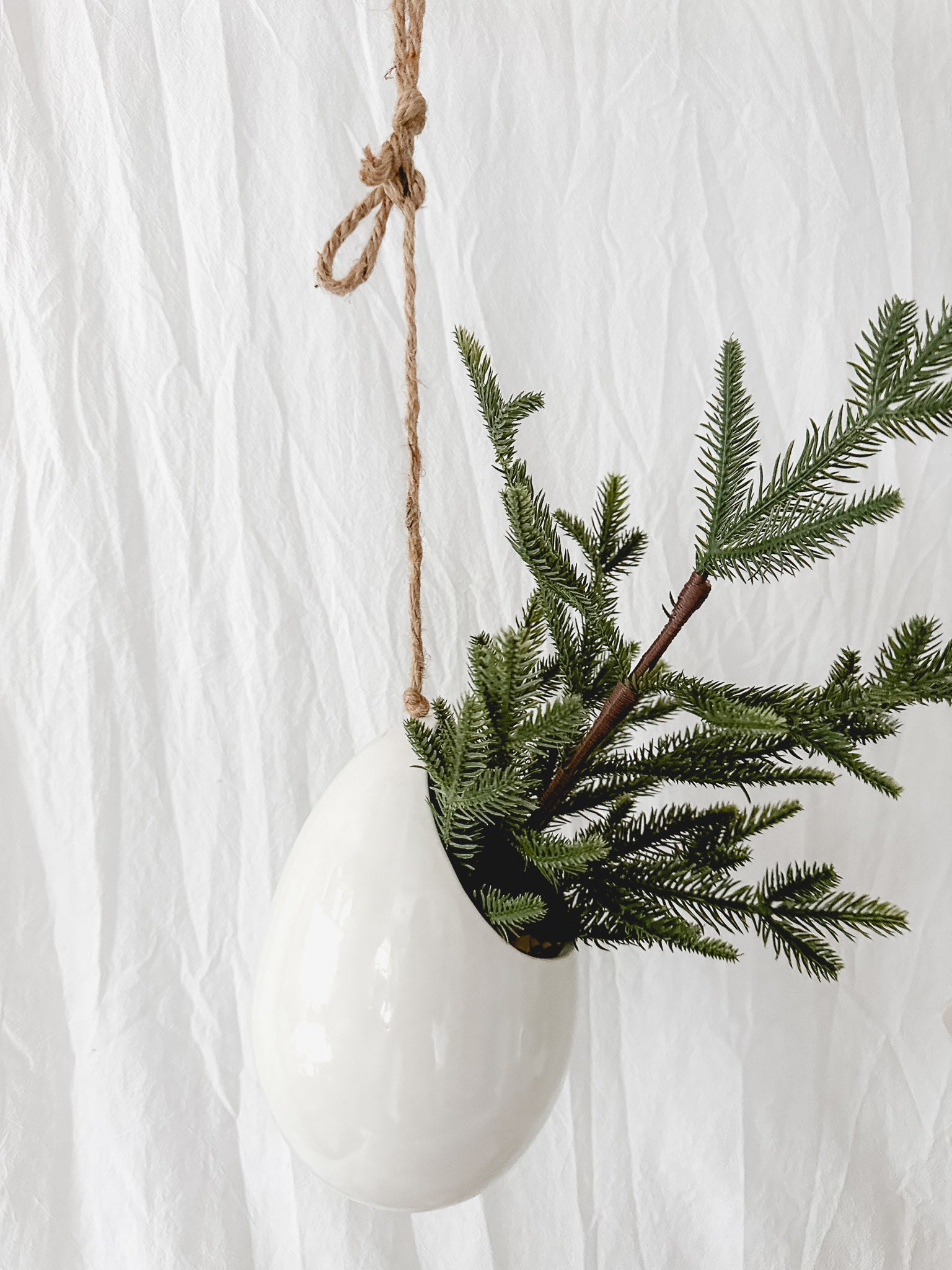 Handmade gloss white ceramic pod-shaped hanging vessel on an 18-inch rope, for flowers or trailing plants, seconds-sale piece from Muddy Heart