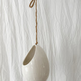 Handmade gloss white ceramic pod-shaped hanging vessel on an 18-inch rope, for flowers or trailing plants, seconds-sale piece from Muddy Heart