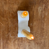 Handmade ceramic wiggle candelabra with organic free-form curves holding two taper candles.