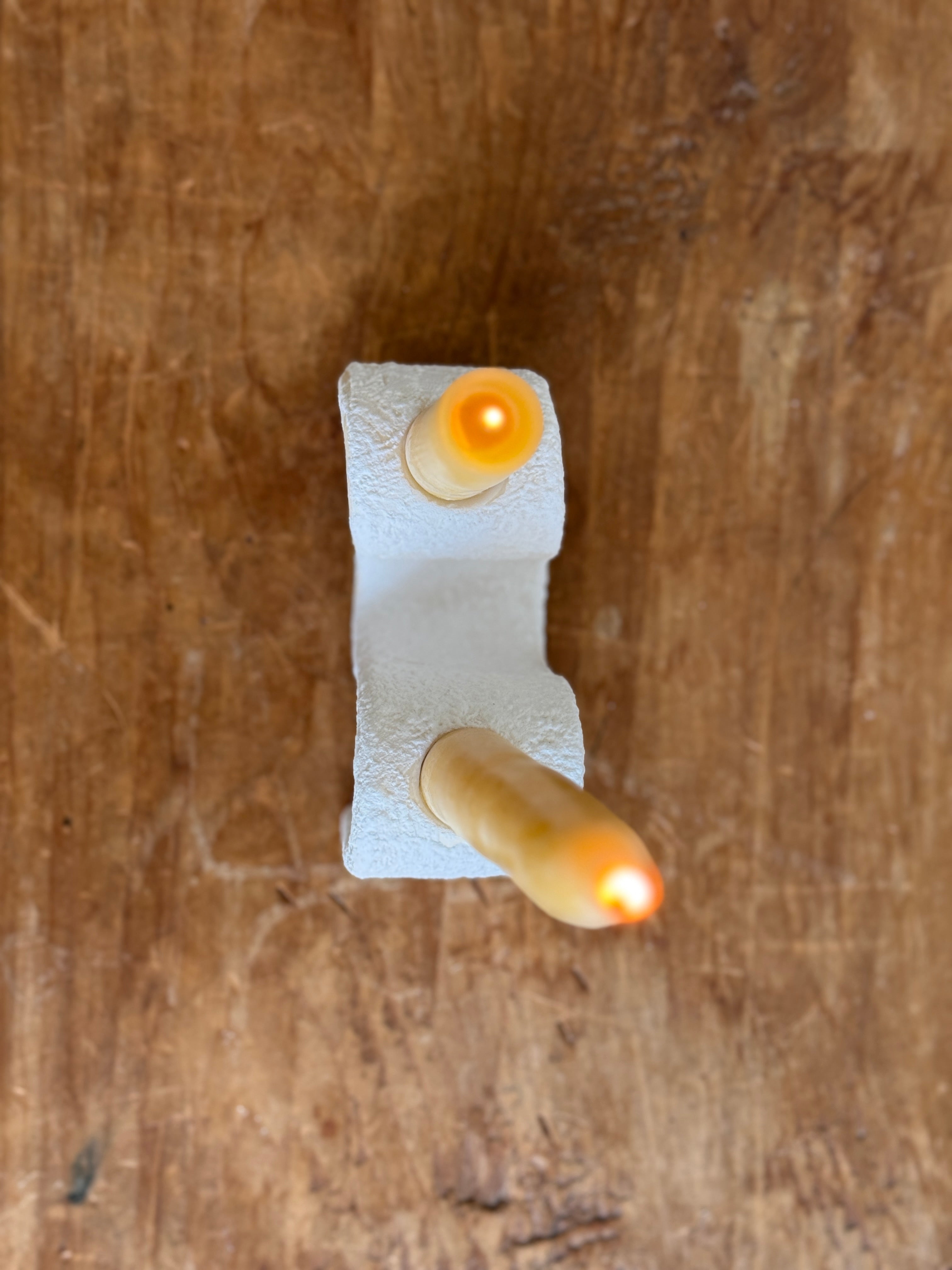 Handmade ceramic wiggle candelabra with organic free-form curves holding two taper candles.
