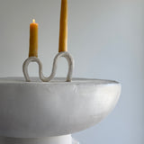 Handmade ceramic wiggle candelabra with organic free-form curves holding two taper candles.