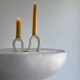 Handmade ceramic wiggle candelabra with organic free-form curves holding two taper candles.