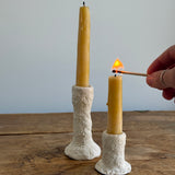 Trio of handmade ceramic candlesticks in varied heights for taper candles.