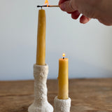 Trio of handmade ceramic candlesticks in varied heights for taper candles.