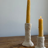 Trio of handmade ceramic candlesticks in varied heights for taper candles.