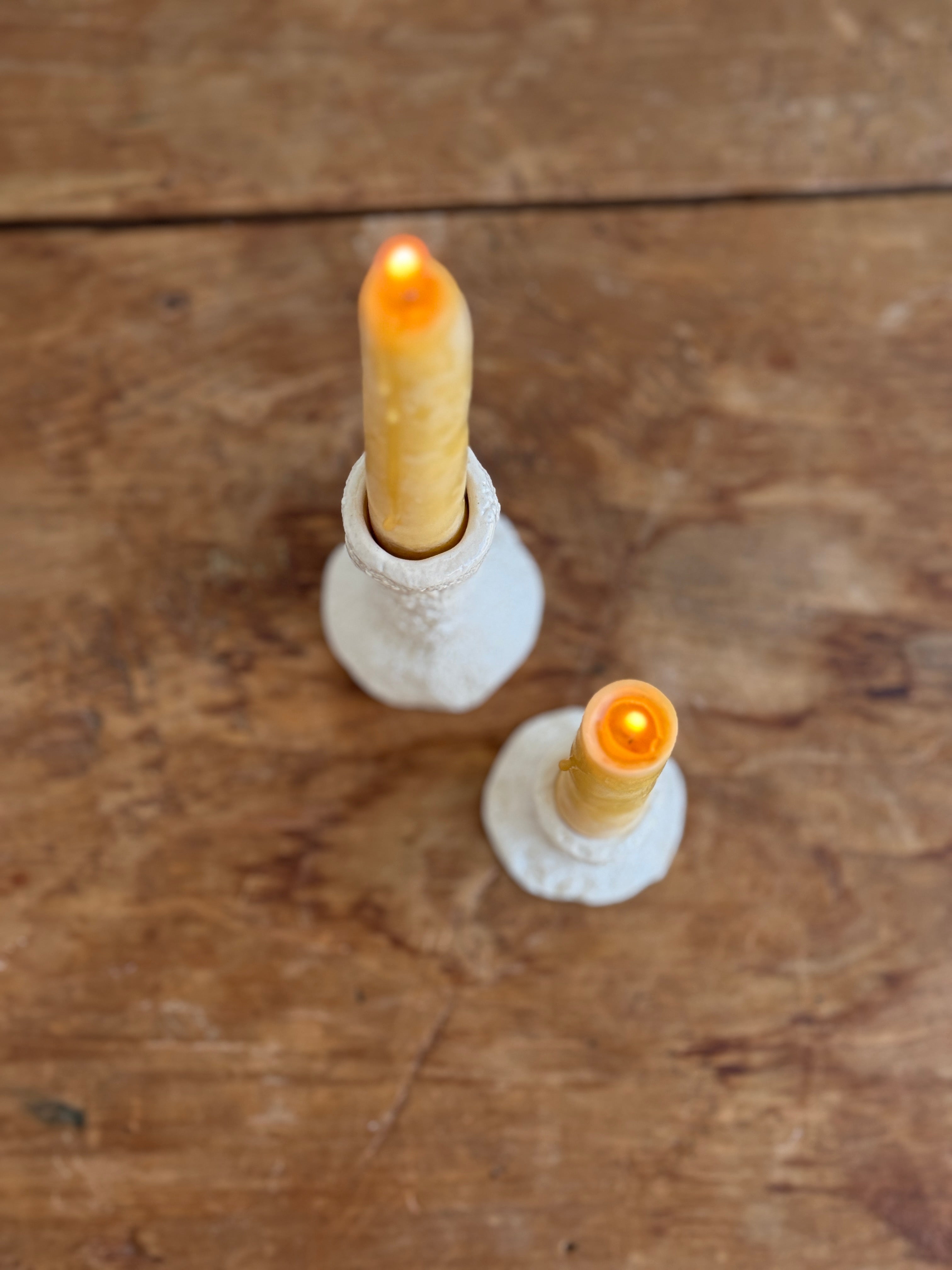 Trio of handmade ceramic candlesticks in varied heights for taper candles.