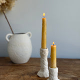 Trio of handmade ceramic candlesticks in varied heights for taper candles.