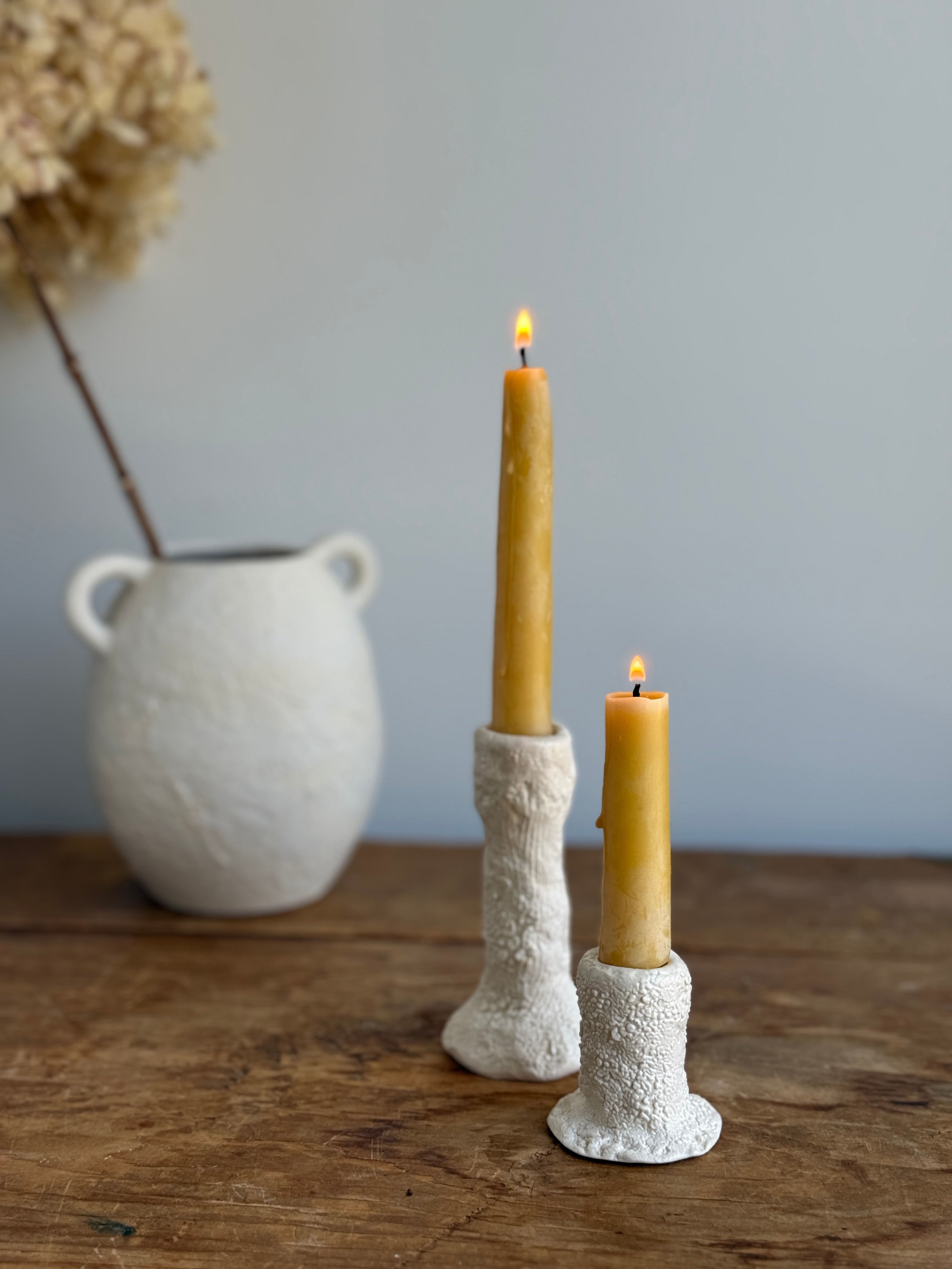 Trio of handmade ceramic candlesticks in varied heights for taper candles.