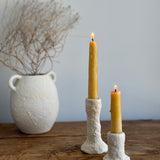 Trio of handmade ceramic candlesticks in varied heights for taper candles.