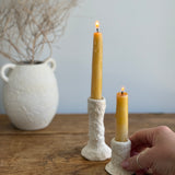 Trio of handmade ceramic candlesticks in varied heights for taper candles.