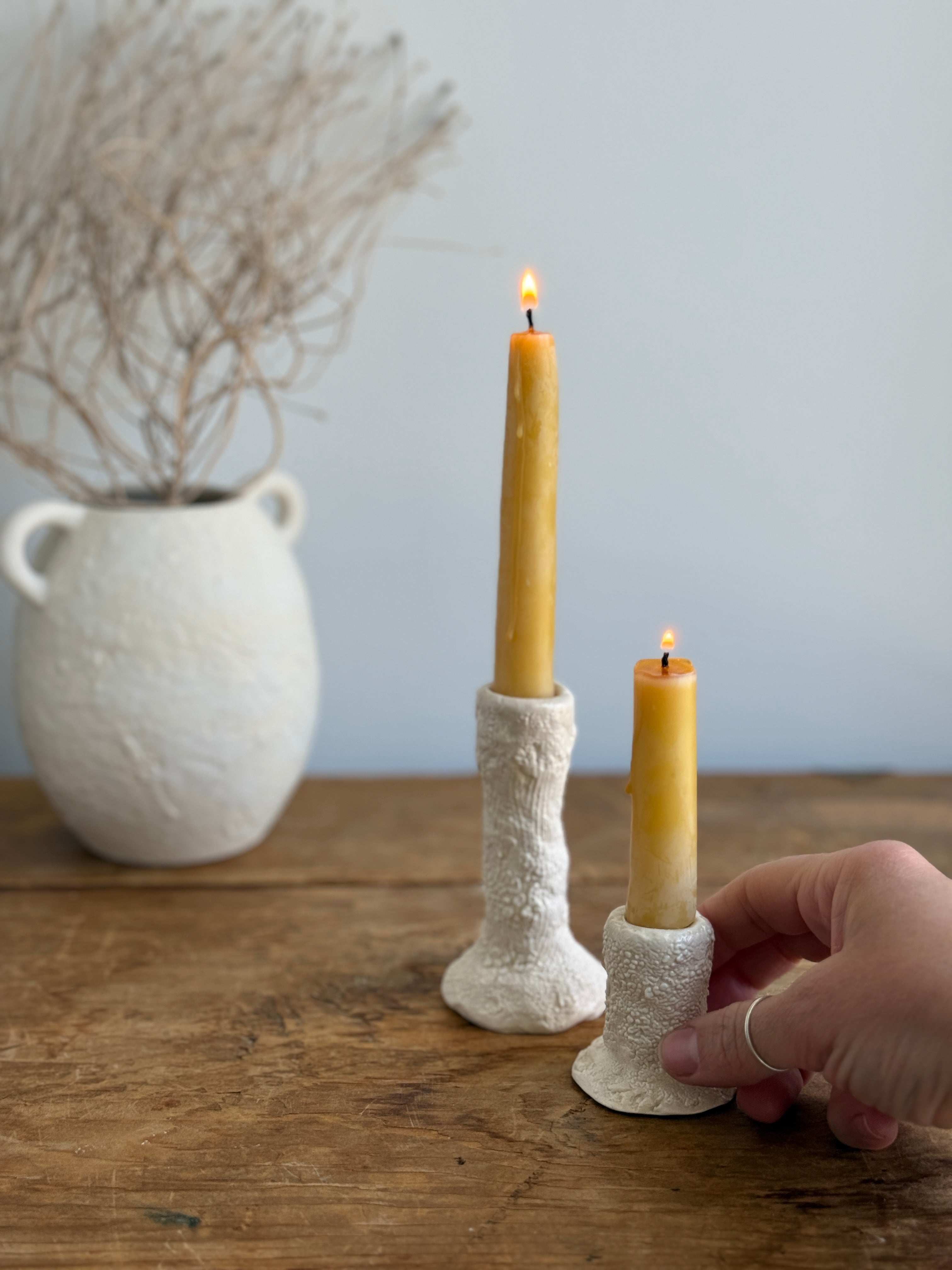 Trio of handmade ceramic candlesticks in varied heights for taper candles.