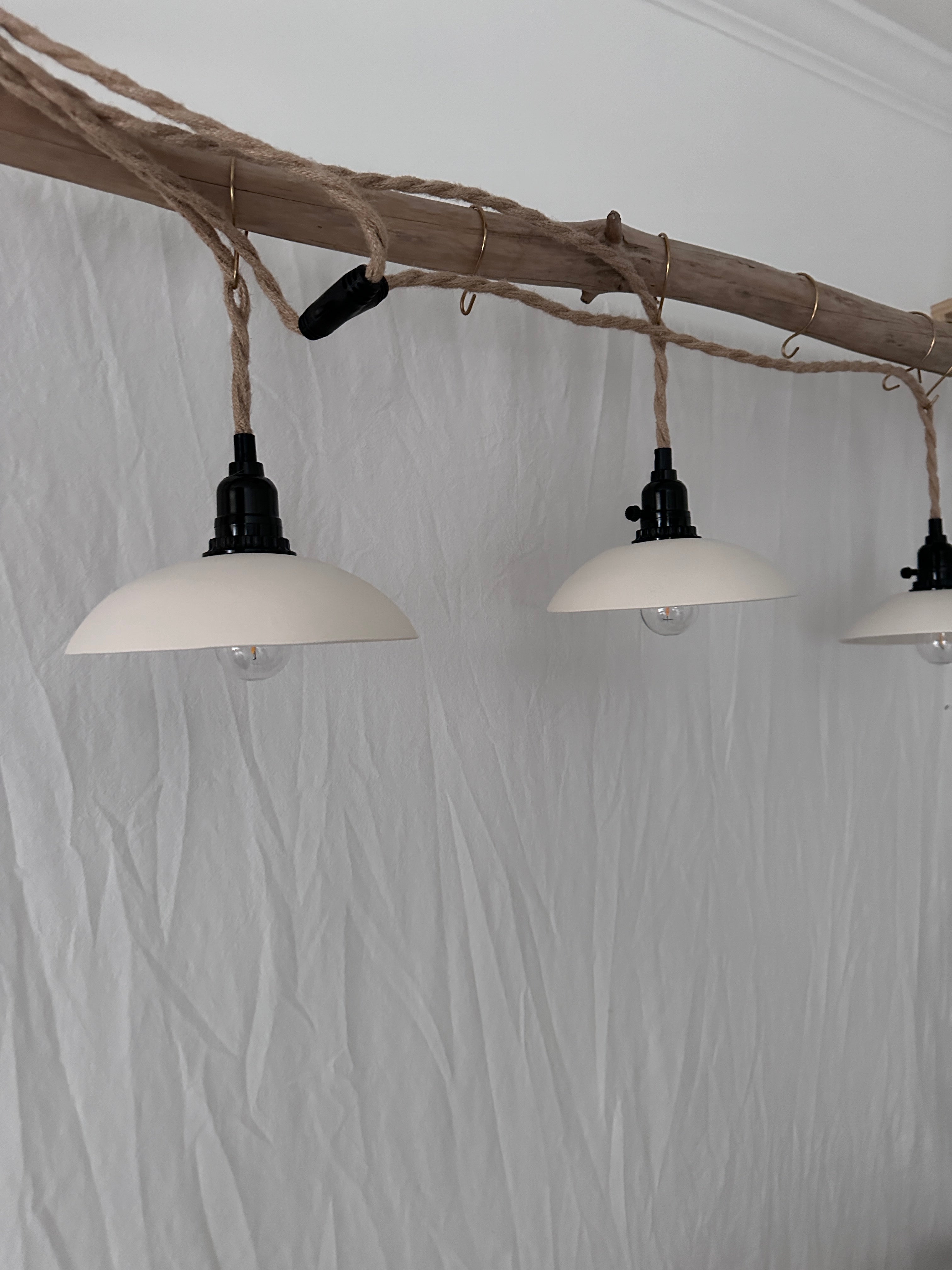 Neutral ceramic plug-in pendant trio for whole-room lighting