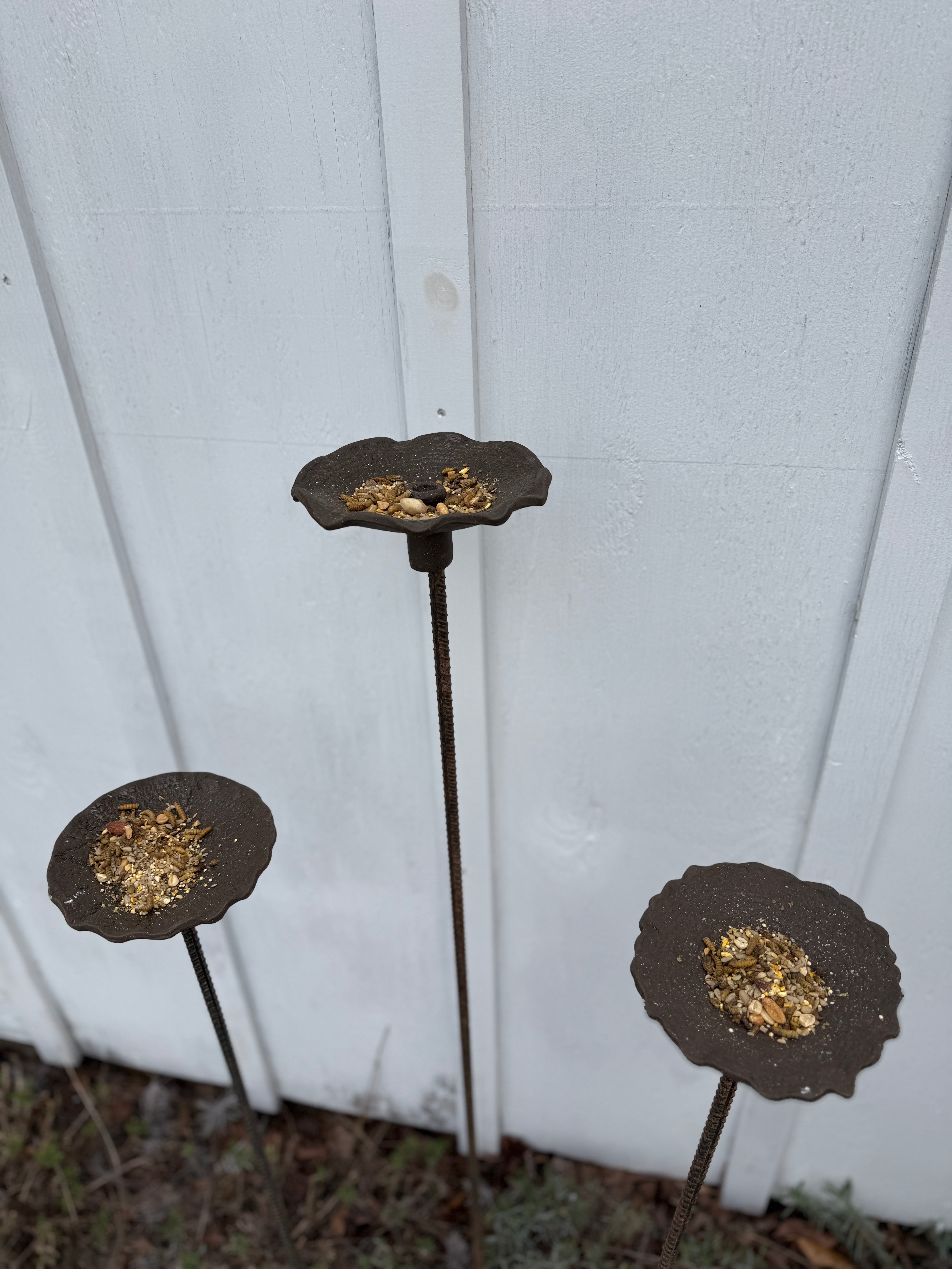 Handmade stoneware bird feeder and bath with pressed flower and leaf detailing for the garden.