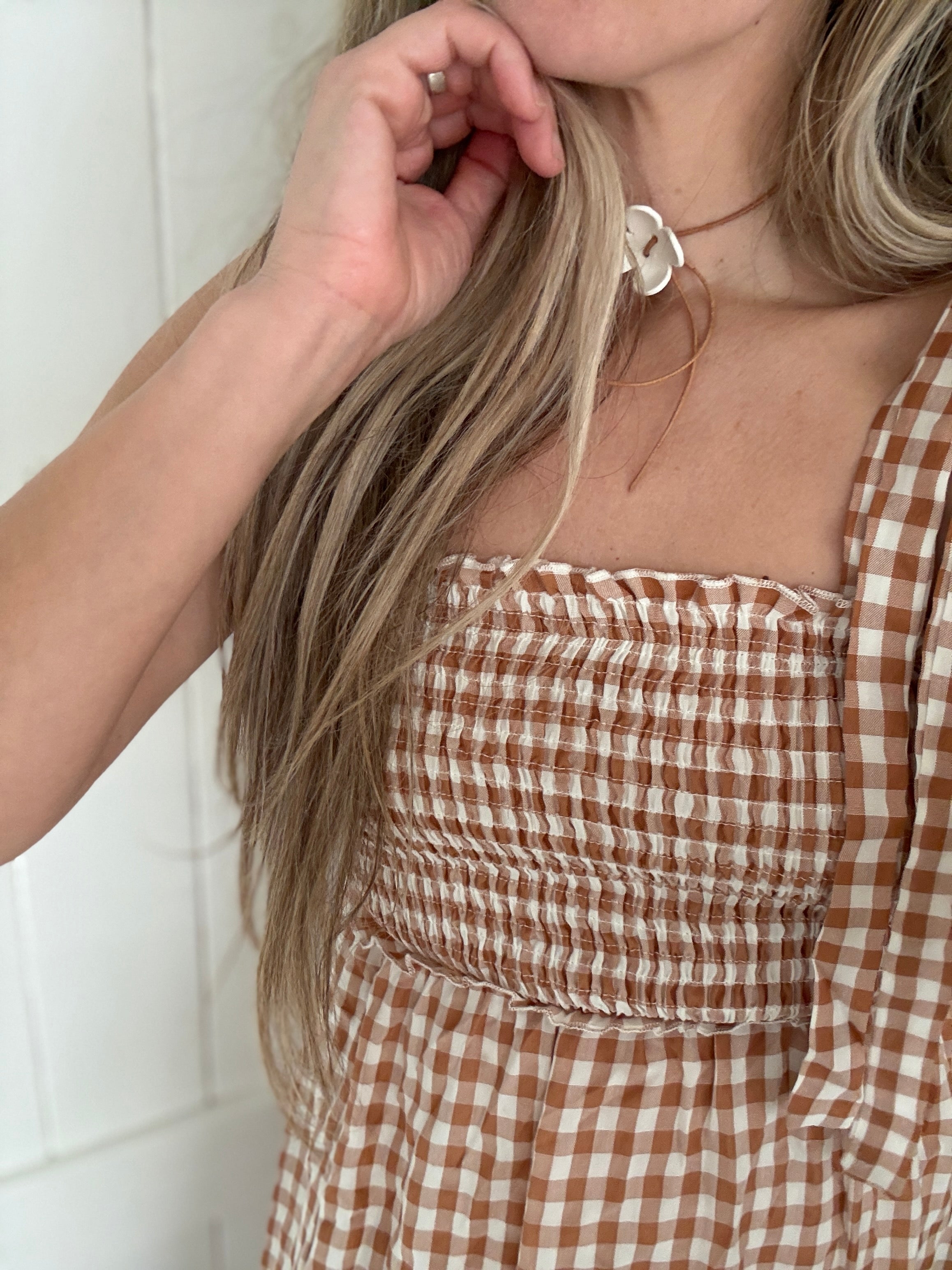 Handmade porcelain dogwood flower choker necklace on an adjustable leather cord.