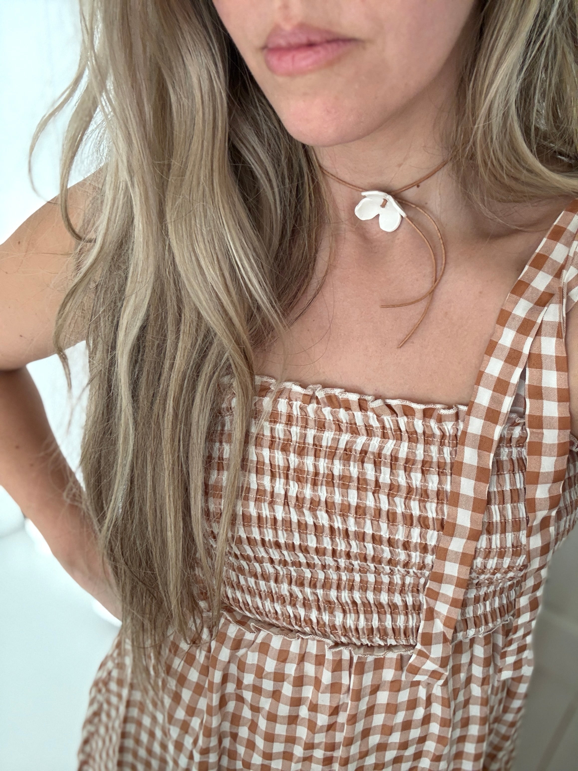 Handmade porcelain dogwood flower choker necklace on an adjustable leather cord.