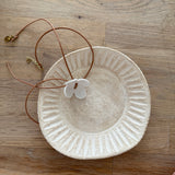 Handmade porcelain dogwood flower choker necklace on an adjustable leather cord.