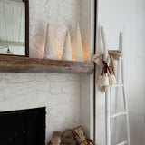 Handmade stoneware tree luminary with star cutouts glowing from an LED tea light
