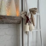 Handmade stoneware tree luminary with star cutouts glowing from an LED tea light