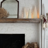 Handmade stoneware tree luminary with star cutouts glowing from an LED tea light