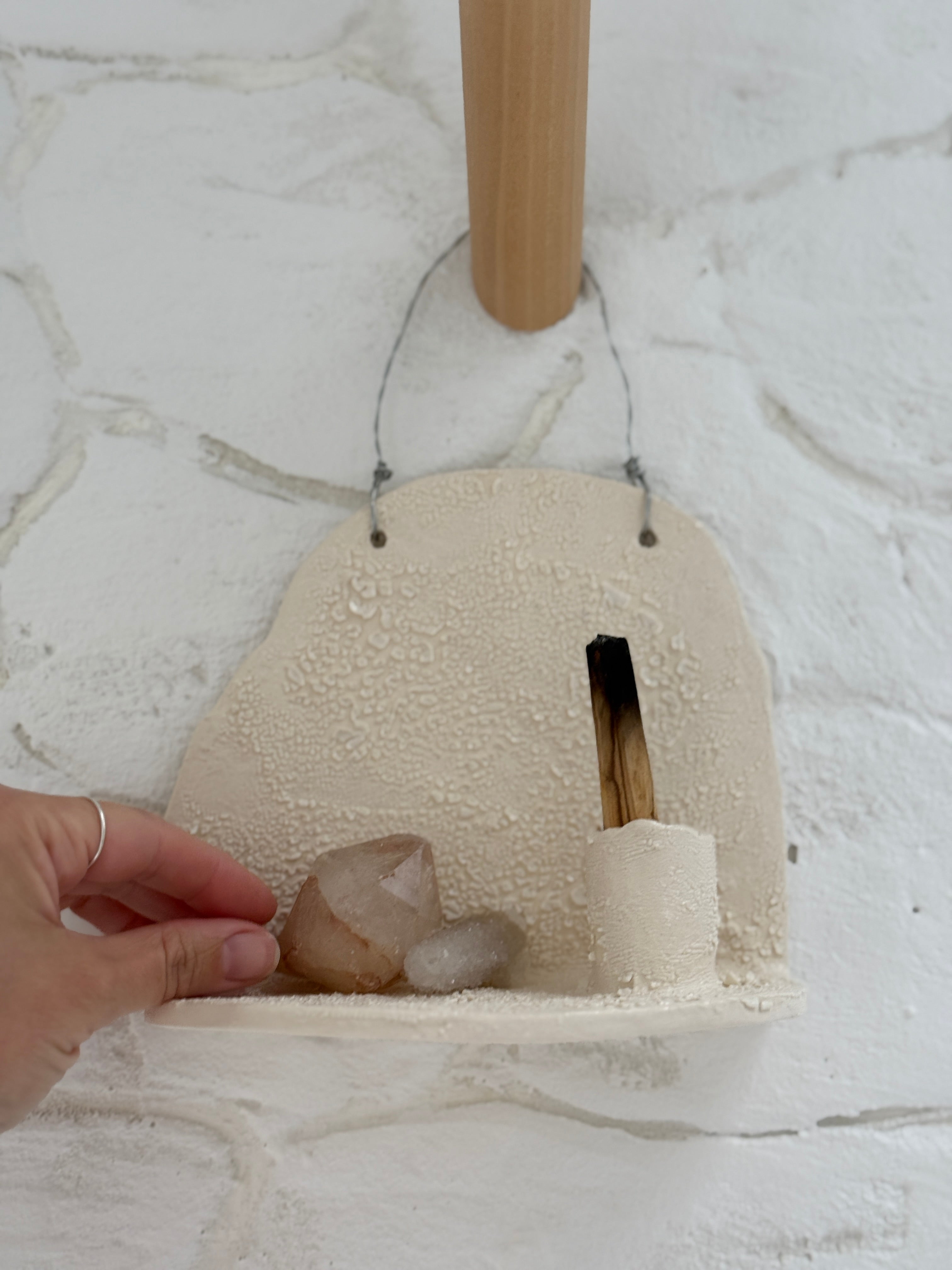 Handmade ceramic wall shelf altar for displaying crystals, candles, or palo santo.