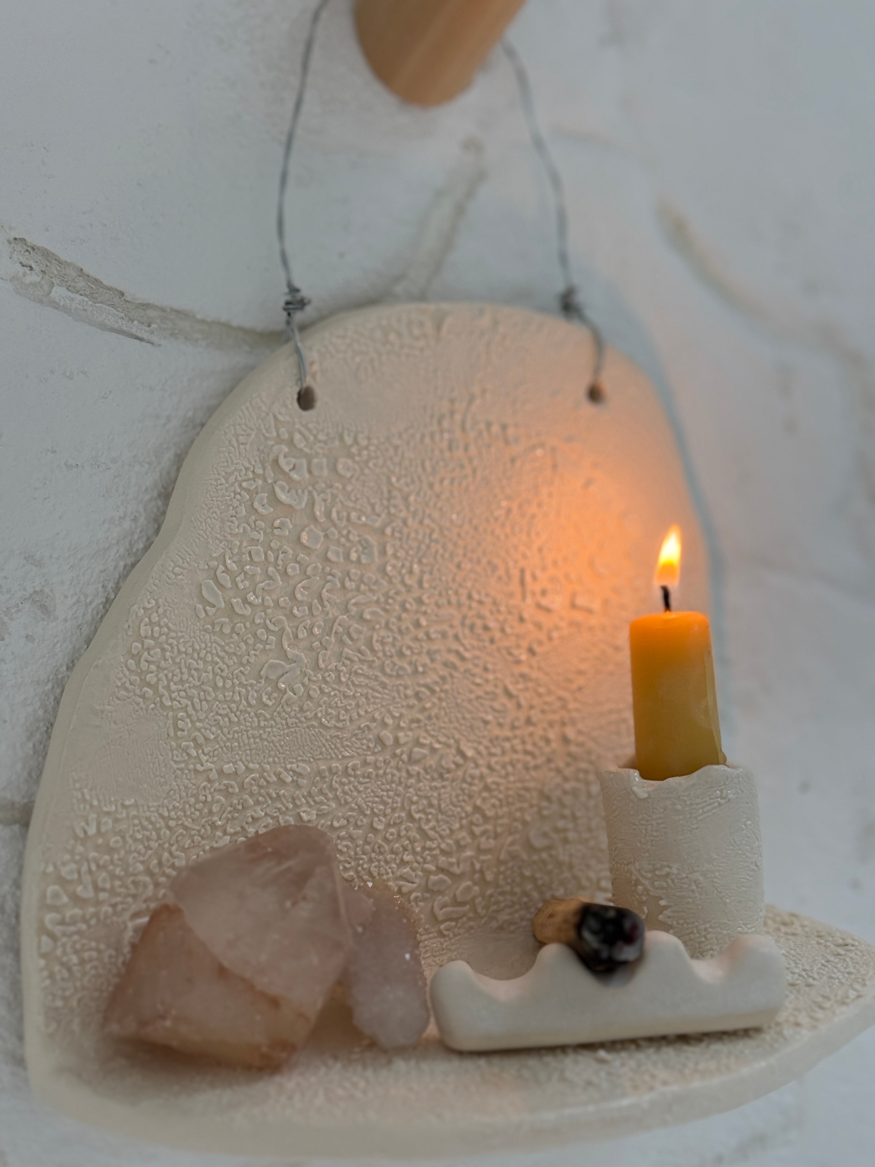 Handmade ceramic wall shelf altar for displaying crystals, candles, or palo santo.