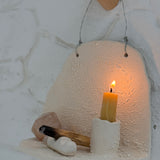 Handmade ceramic wall shelf altar for displaying crystals, candles, or palo santo.